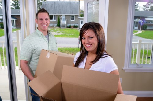 Family loading boxes into a mobile storage unit in Westheath